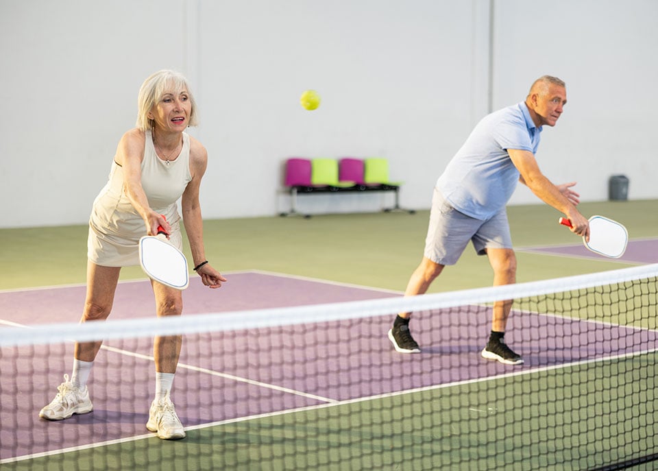 Active seniors playing pickleball