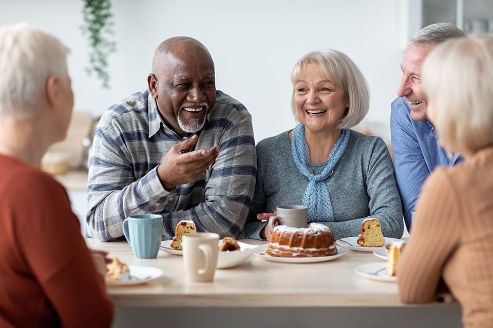 Seniors enjoying coffee and lively conversation